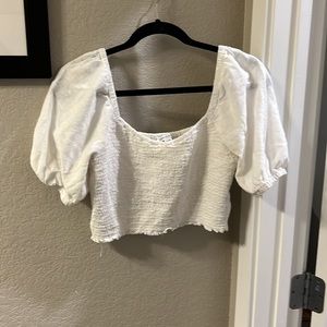 White cropped top from American Eagle with puffed sleeves.